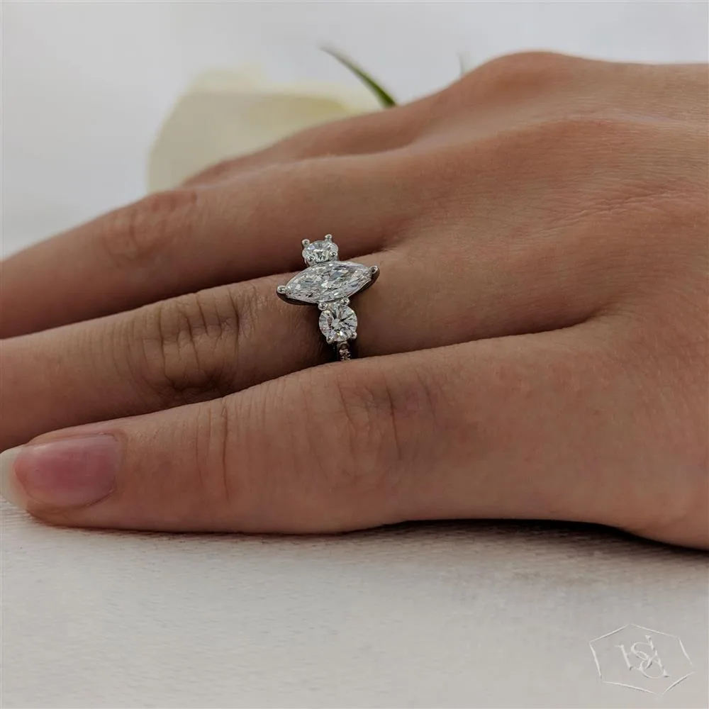 marquise cut diamond in a platinum three stone diamond band