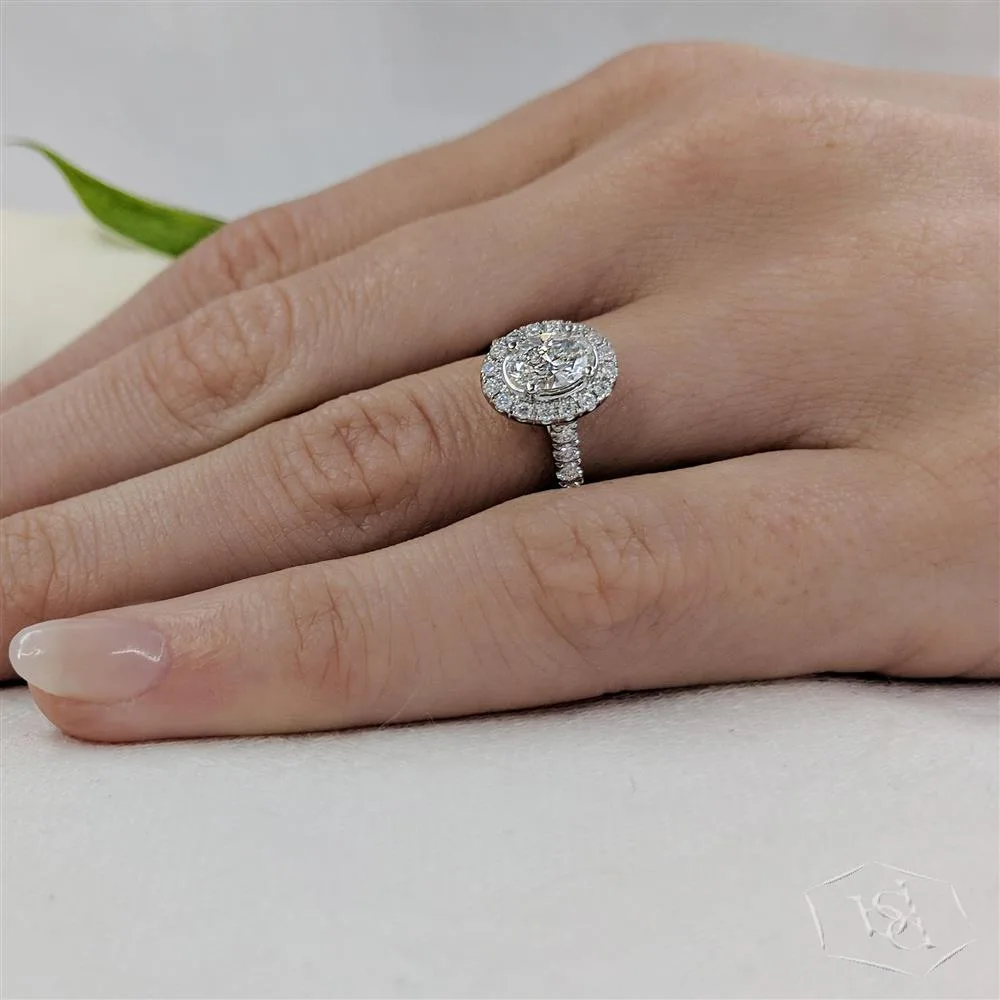 oval cut diamond in a platinum cluster diamond band