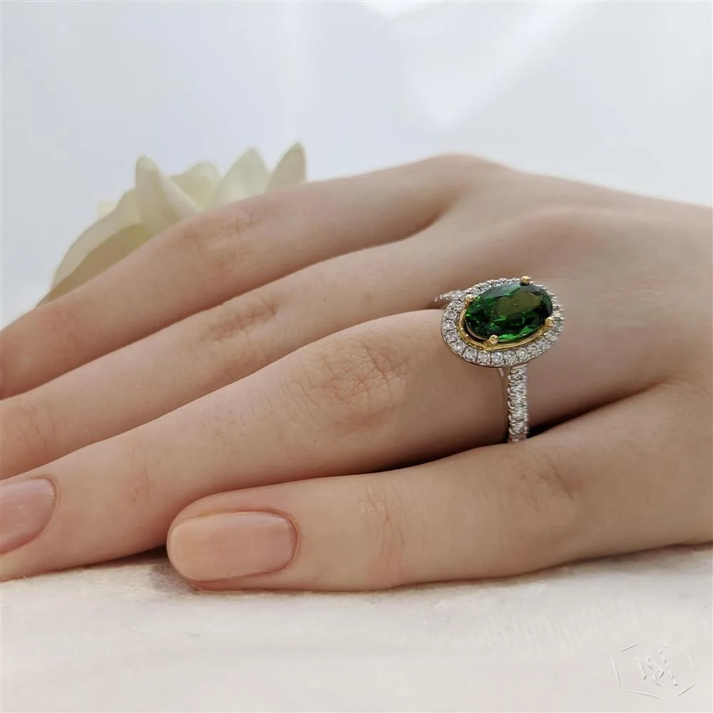 oval cut green tourmaline in a platinum shank and18ct yellow gold head cluster diamond band