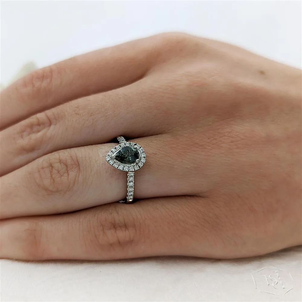 pear shape cut teal sapphire in a platinum cluster diamond band