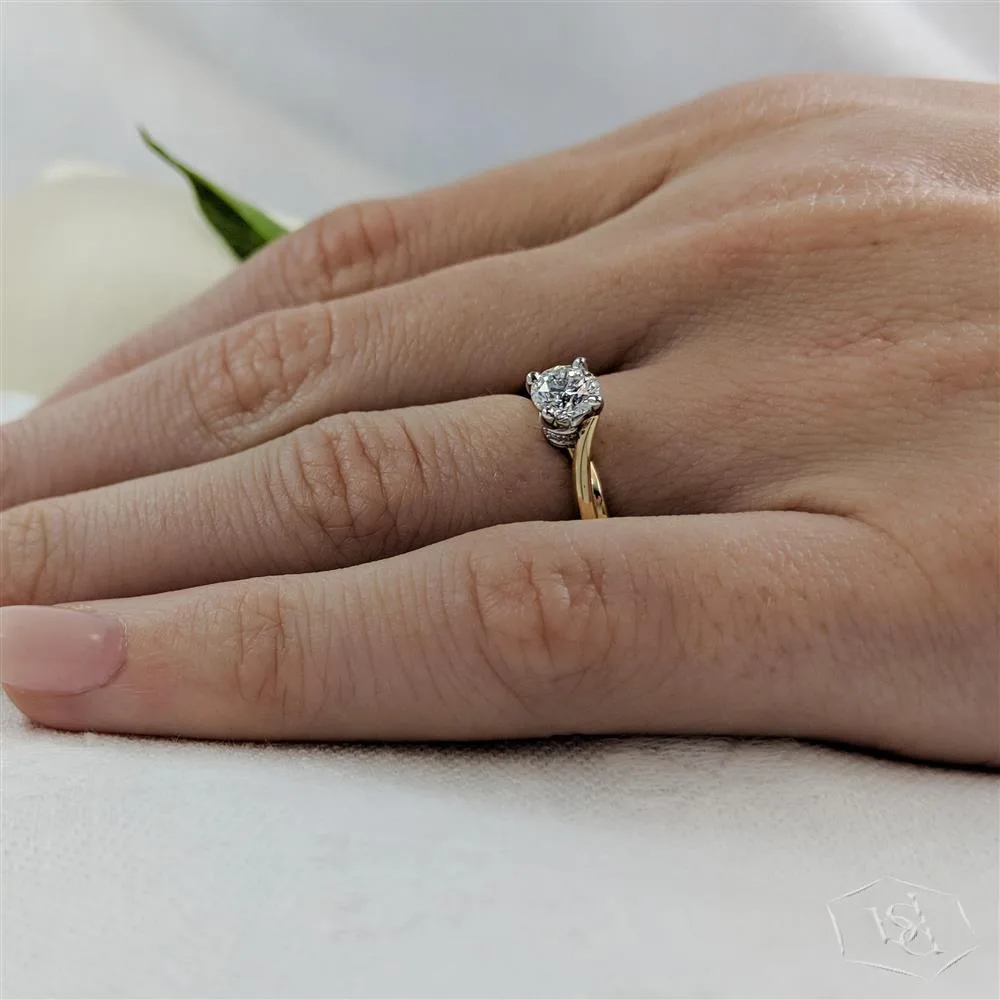 round brilliant cut diamond in a 18ct yellow gold shank and platinum head solitaire plain band